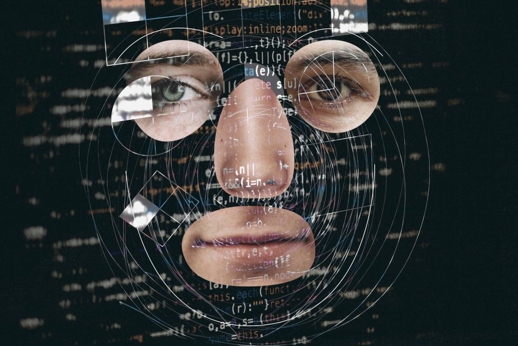 Computer screen displays lines of code beneath a human face, representing the concept of brand intelligence